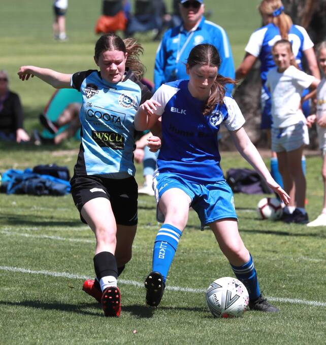 KEY PLAYER: Cootamundra's Michaela Webb tries to win the ball back off Tolland's Ingrid Weir during finals. Webb has been one of the Strikers' best players this season. Picture: Les Smith