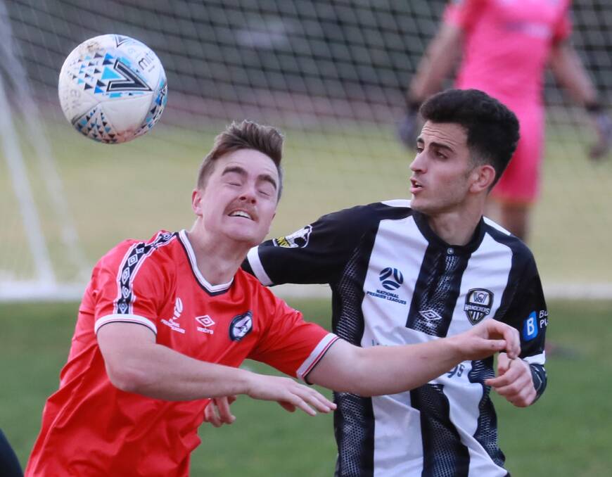 HEADS UP: Weston Molonglo's John O'Gorman and Wagga City Wanderers' Watban Ibrahim battle it out at Gissing Oval on Saturday. Picture: Les Smith