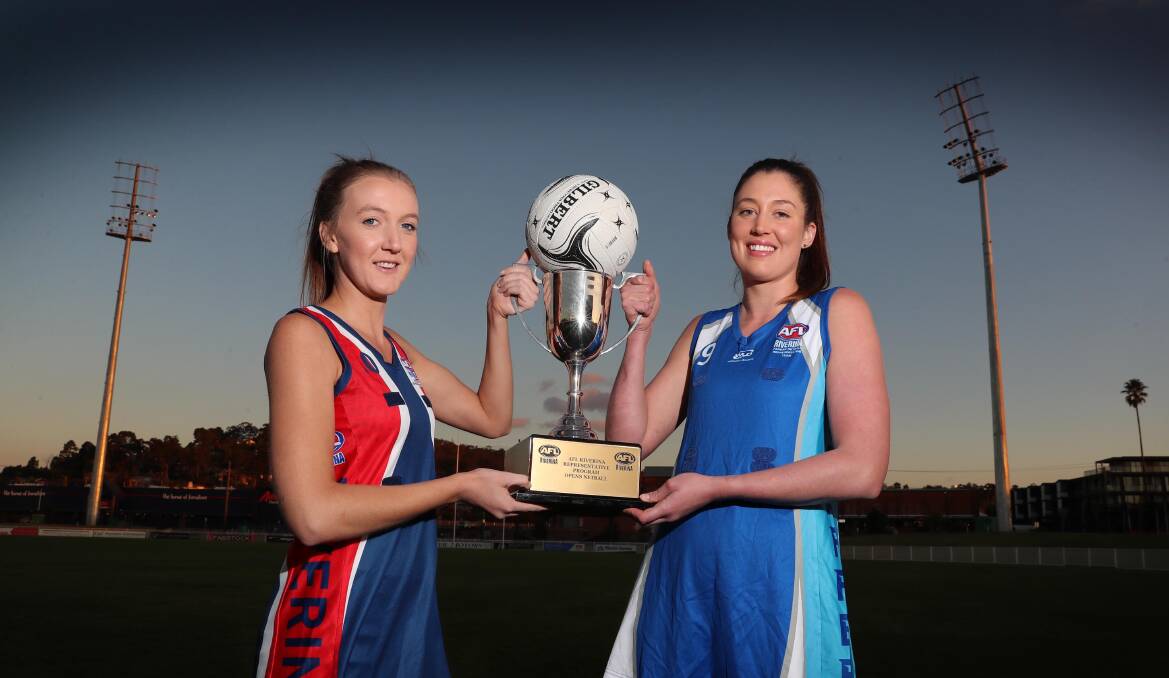 SHOWTIME: Riverina League's Jess Allen and Farrer League counterpart Jordan Barrett eye off the prize for Saturday's game. Picture: Les Smith