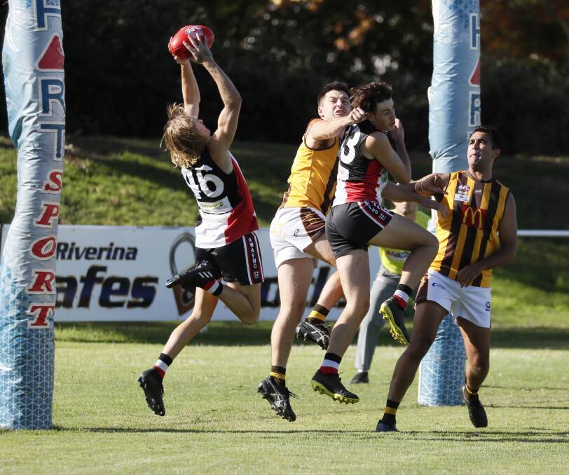 STRONG: North Wagga's Bailey Clark takes a mark over the back of the pack in the goal square in the Farrer League game against East Wagga-Kooringal at McPherson Oval on Saturday. Picture: Les Smith