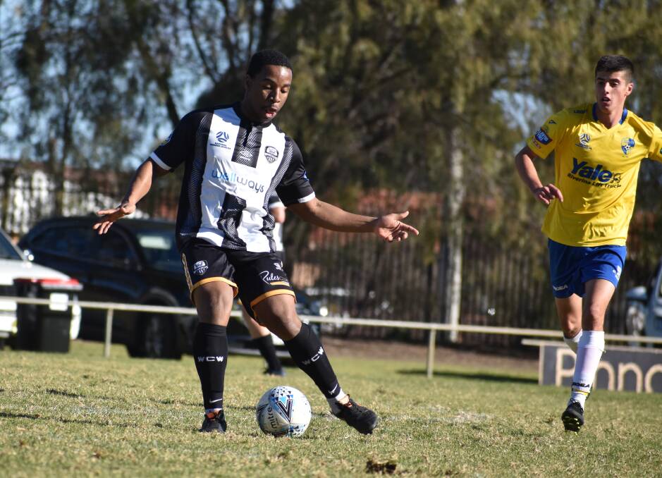 TOUCH: Wagga City Wanderers' Alvaro Kelechi gets a pass away in the 6-2 loss to Yoogali SC at Griffith on Sunday. Picture: Liam Warren
