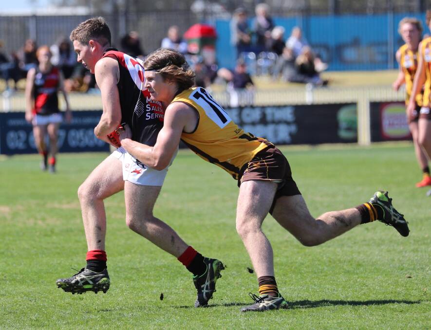 CAUGHT: Marrar's Nick Cawley is wrapped up by East Wagga-Kooringal's Troy Piercy in the 2019 Farrer League under 17 grand final at Robertson Oval. Picture: Les Smith