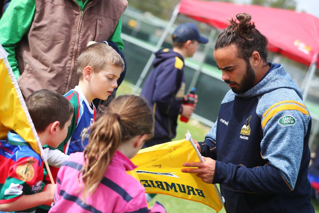POPULAR: Brumbies back Andy Muirhead signs autographs at the Southern Inland gala day at Jubilee Park on Sunday. Picture: Emma Hillier
