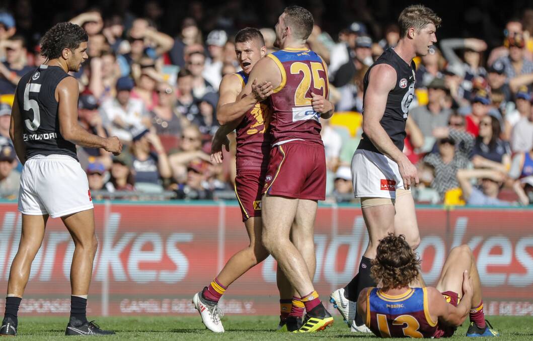 Jake Barrett celebrates kicking a goal against Carlton in the round 16 game at The Gabba this year.