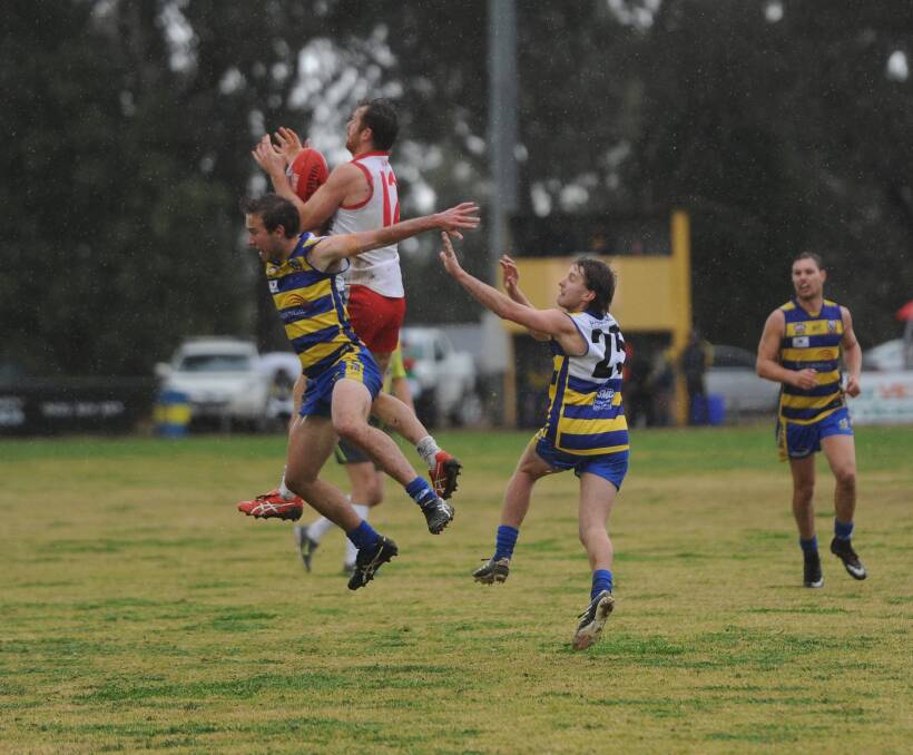 BIG MARK: Griffith's Heath Northey flies high into a pack to mark against MCUE at Mangoplah Sportsground on Saturday. Picture: Matt Malone