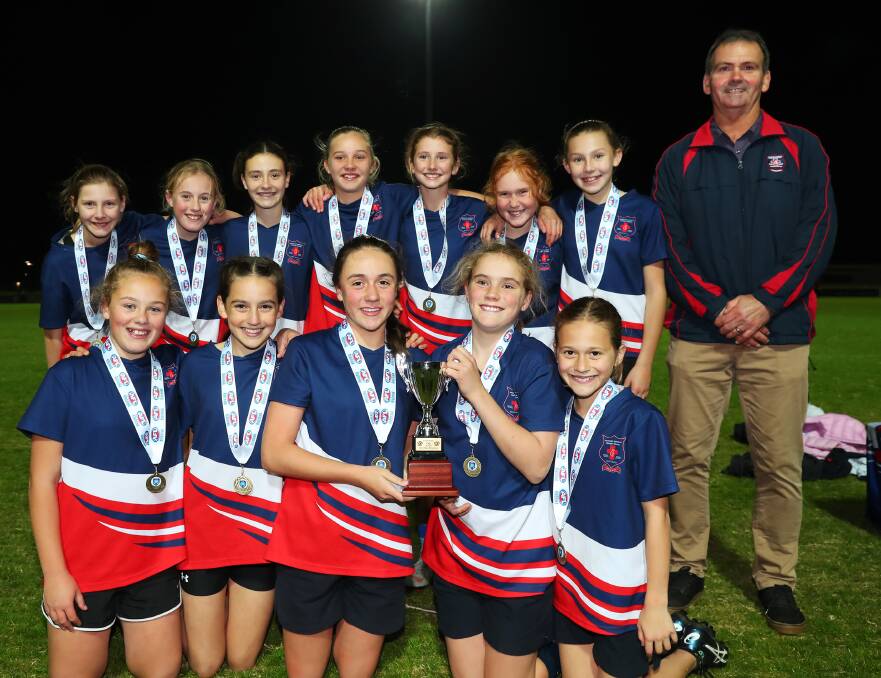 GIRL POWER: Mater Dei Primary School's girl's team are all smiles after their Paul Kelly Cup win on Wednesday night. 