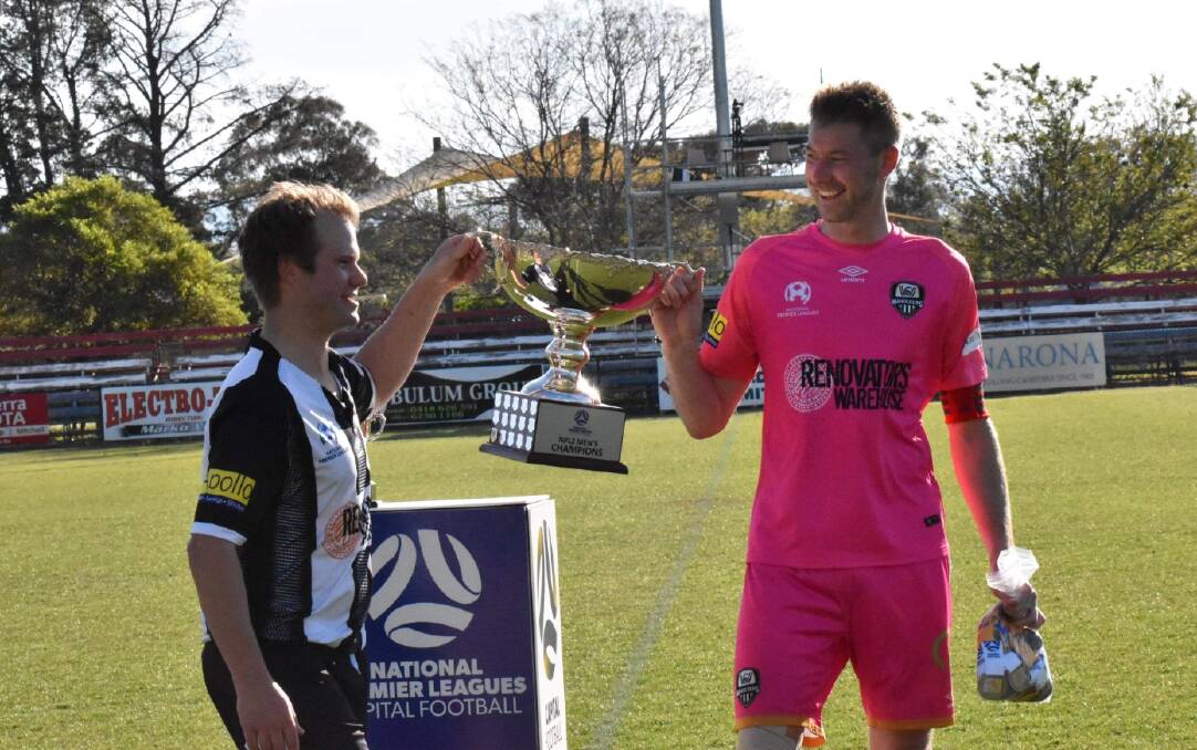 SPECIAL MOMENT: Wanderers co-captains Carl Pideski and Robert Fry lift the NPL Two premiership cup aloft on Sunday. Picture: Piper Streatfield
