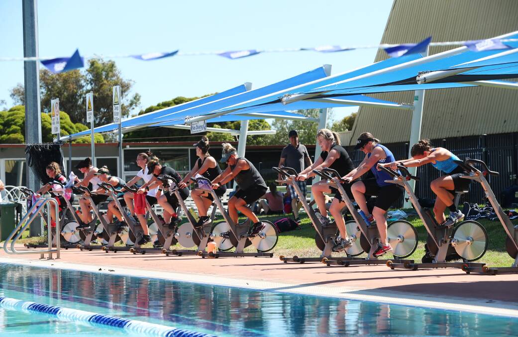 OFF AND RACING: Competitors take part in the bike component of the women's only triathlon at Oasis Regional Aquatic Centre on Saturday. Picture: Emma Hillier