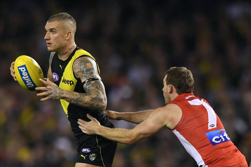 Harry Cunningham applies pressure to Richmond's Dusty Martin in their clash earlier in the year.