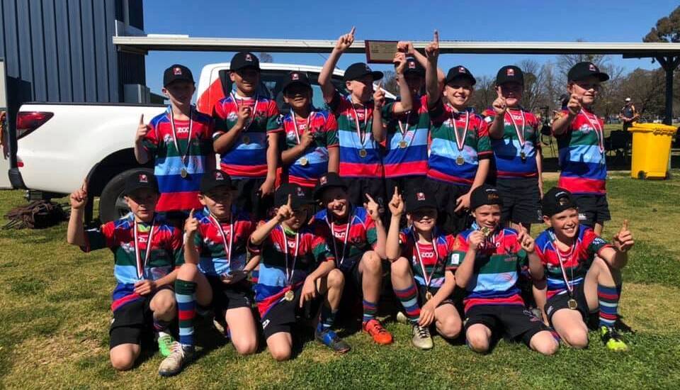 CHAMPIONS: Wagga's under 10 rugby team celebrate their grand final win over Young at Cootamundra on Sunday.