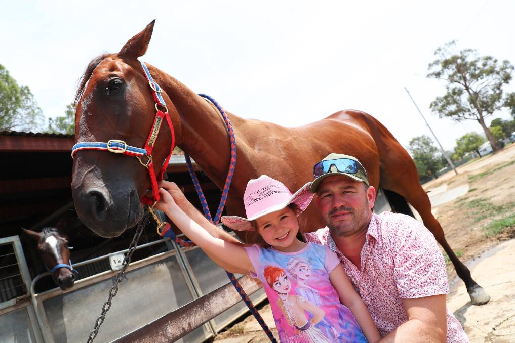 SPECIAL BOND: Brett Hogan and five-year-old daughter Pippa with Beach Wreck ahead of his start at Wagga on Tuesday night. Picture: Emma Hillier