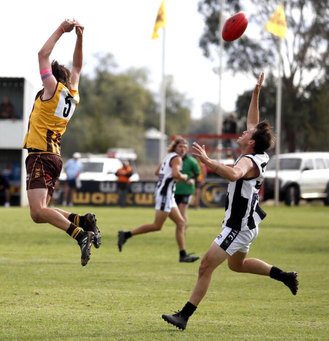 The Rock-Yerong Creek's Jesse Cool looks to get his hands on the footy as East Wagga-Kooringal's Jarrod Turner goes up for a mark at Gumly Oval on Saturday. Picture: Les Smith