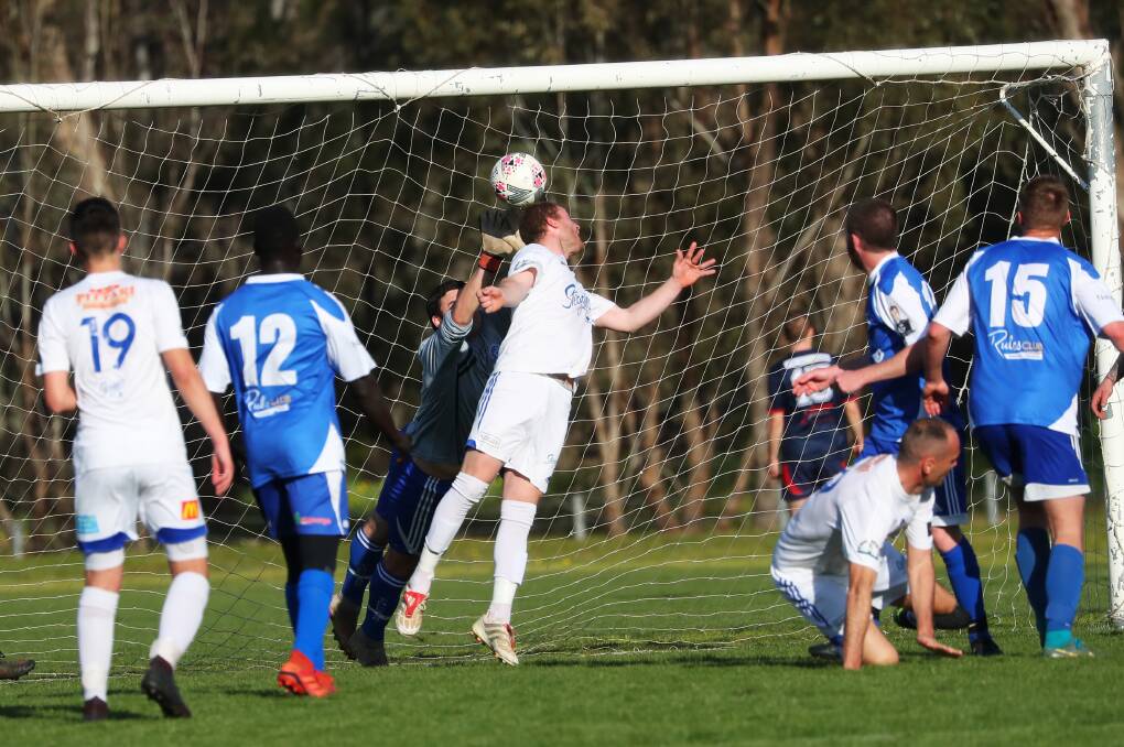 GOAL: Hanwood striker Daniel Johnson gets his head to the ball to beat the Tolland keeper in the Pascoe Cup game at Rawlings Park on Sunday. Picture: Emma Hillier