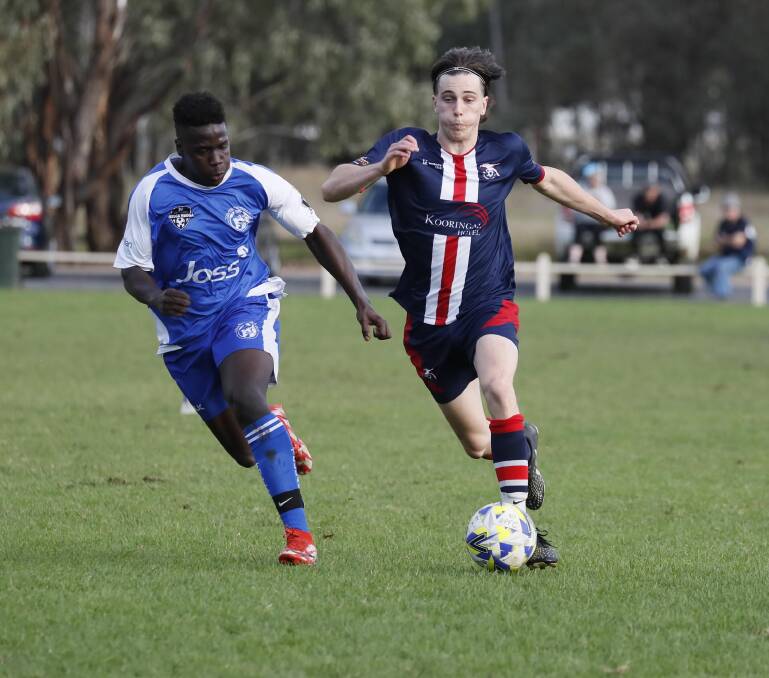 ON THE RUN: Henwood Park's Lewis Crowley looks to get away from Tolland's Rodreck Danda in the Pascoe Cup game at Rawlings Park on Sunday. Picture: Les Smith