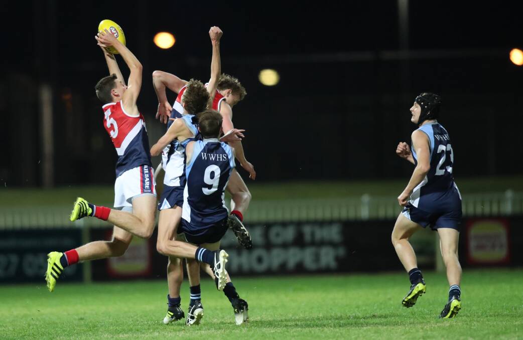 GOOD HANDS: Kildare full-forward Brad Ashcroft takes a big mark against Wagga High School on Wednesday night. Picture: Les Smith