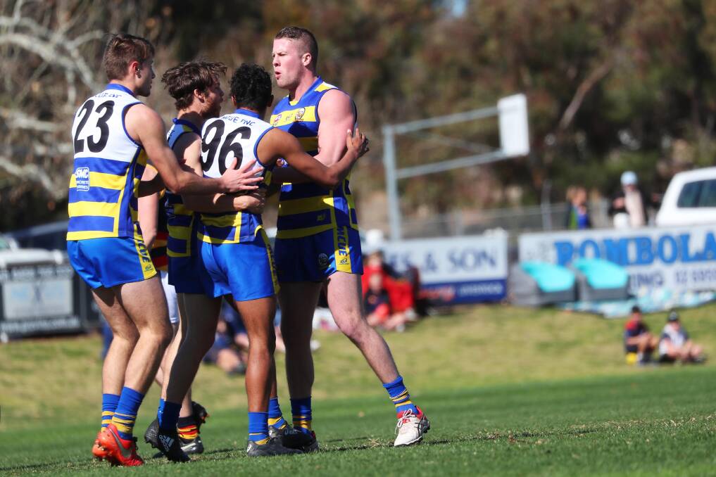 EARLY ON: MCUE celebrate a Brent Arho goal in the first quarter. Picture: Emma Hillier