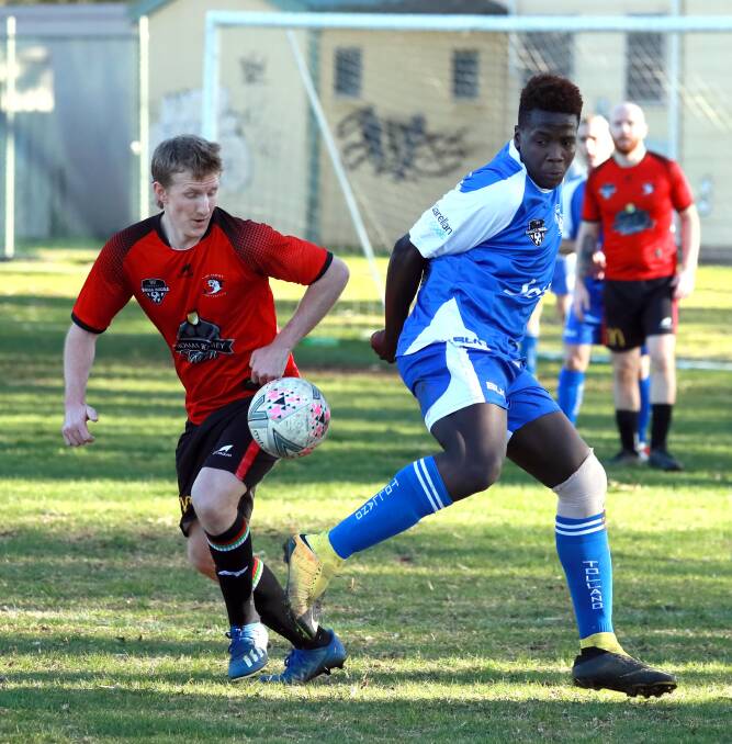 DELAYED: The Football Wagga season has been pushed back a week. Pictured playing last season is Lake Albert's Mat Kleine and Tolland's Rodreck Danda. Picture: Les Smith
