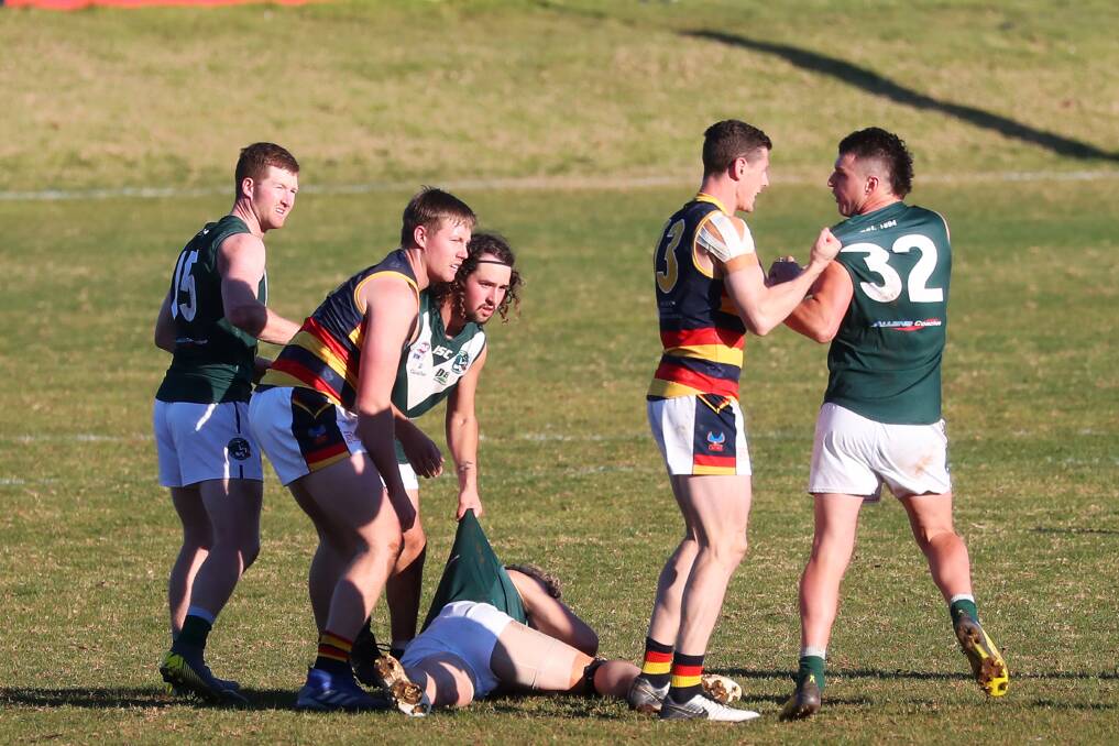 UP FOR THE FIGHT: Leeton-Whitton coach Sam Darley and Coolamon counterpart Jake Barrett get up close and personal at Kindra Park on Saturday. Picture: Emma Hillier