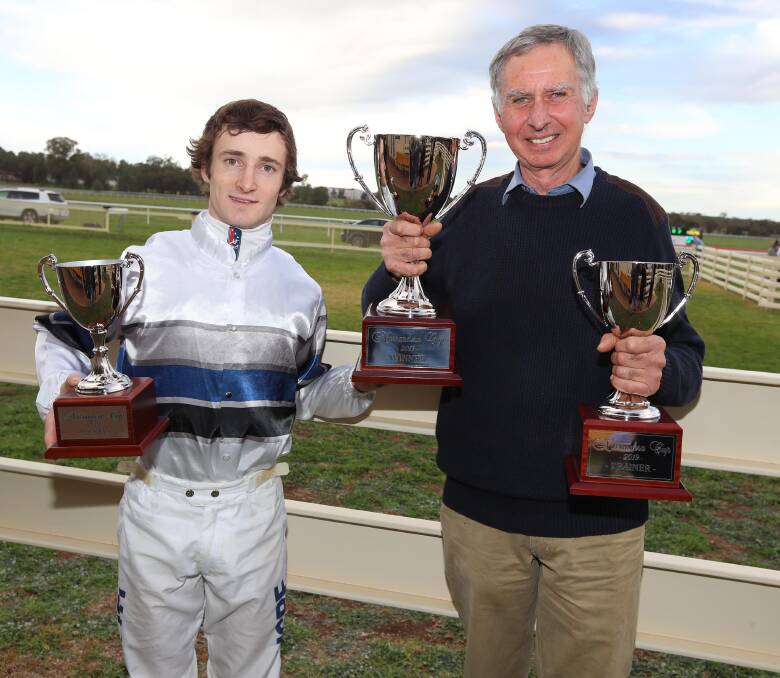 SUCCESS: Wagga apprentice Josh Richards
and Albury trainer Ron Stubbs show off their
spoils after Squidensquizz's Narrandera Cup
victory on Sunday. Picture: Les Smith
