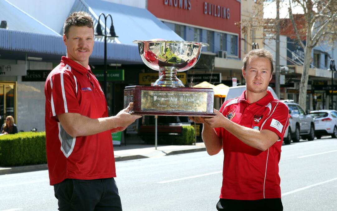 SHOWDOWN: Collingullie-Glenfield Park coach Luke Gestier and Griffith counterpart Will Griggs show off the big prize in Wagga on Thursday. Picture: Les Smith