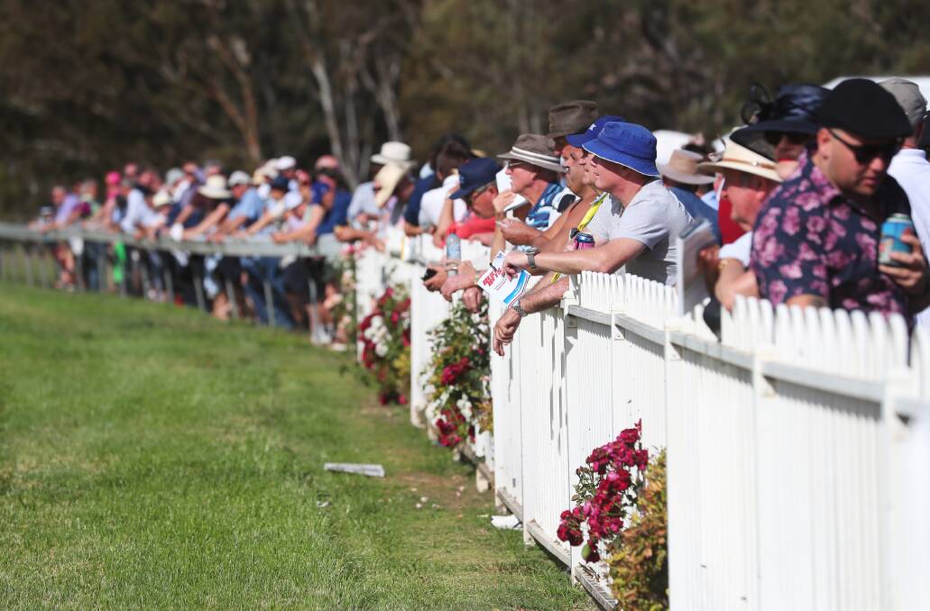 HAPPIER TIMES: Punters line the fence for last year's Snake Gully Cup day at Gundagai. Picture: Emma Hillier