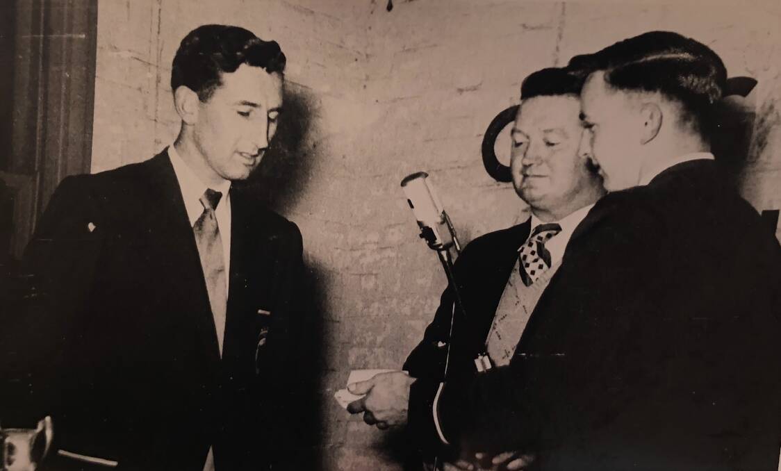 Gil Hoare is presented with a gold watch by Bob Nye and John Garrett after the 1955 premiership success.