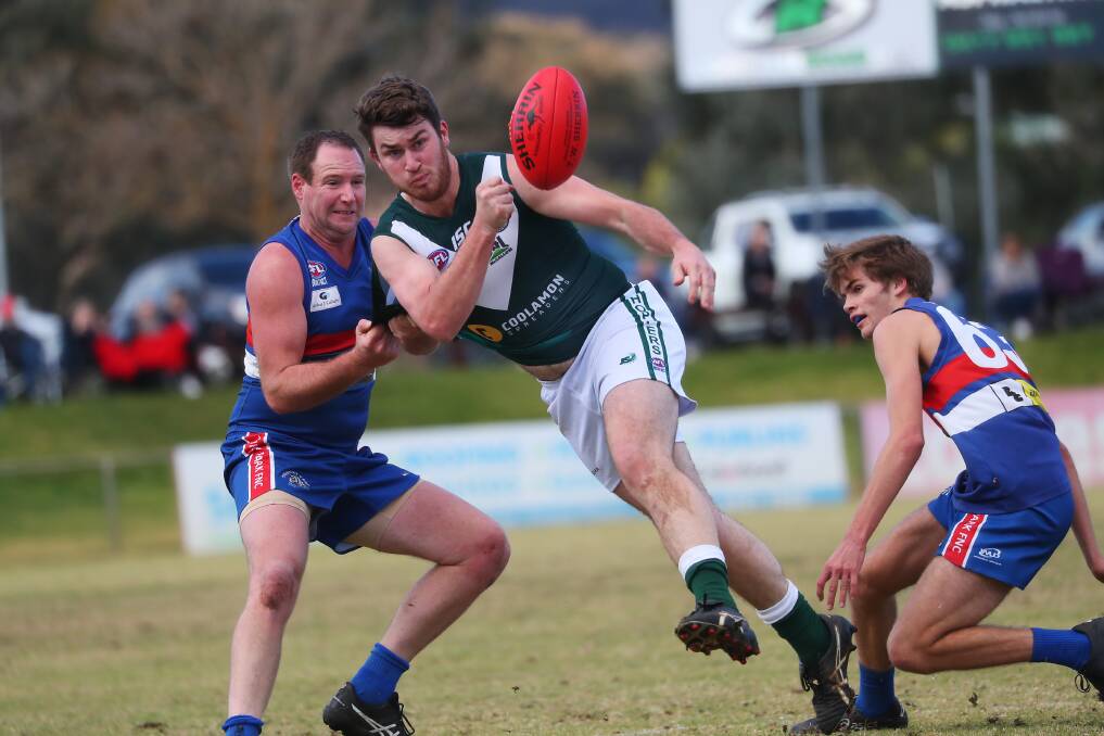 PUNCH: Coolamon's Luke McLoughlin gets a fist to the ball despite pressure from Turvey Park's Chris Cerato and Angus Grigg at Maher Oval on Saturday. Picture: Emma Hillier