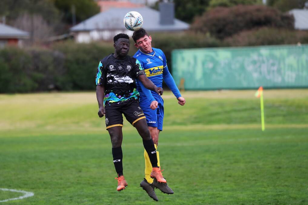 HEAD TO HEAD: Wagga City Wanderers' Jacob Ochieng and Yoogali SC's Samuel Raciti battle it out at Gissing Oval on Saturday. Picture: Emma Hillier