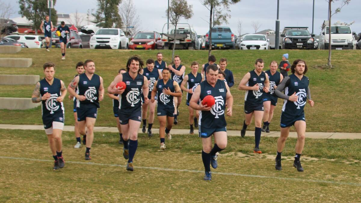 Cootamundra's football team run out onto the ground for a game this season.