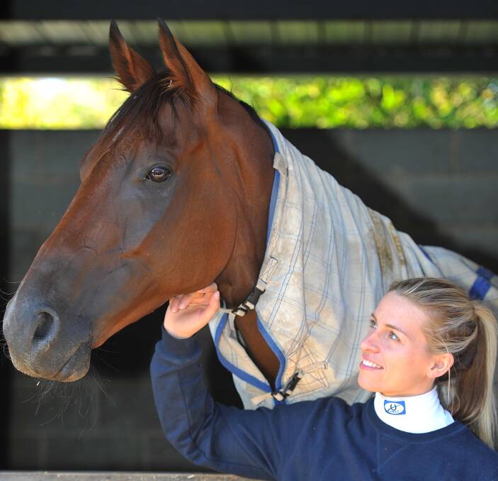 HARD TO BEAT: Wagga apprentice jockey Lily Coombe spends time with Mitchell Road at Chris Heywood's stables in Wagga. Mitchell Road will start favourite at Murrumbidgee Turf Club on Saturday. Picture: Kieren L Tilly