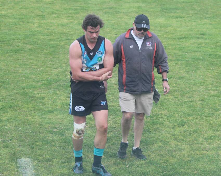 Northern Jets full-forward Matt Wallis comes from the ground with a suspected dislocated elbow in Sunday's first semi-final at Langtry Oval. Picture by Matt Malone