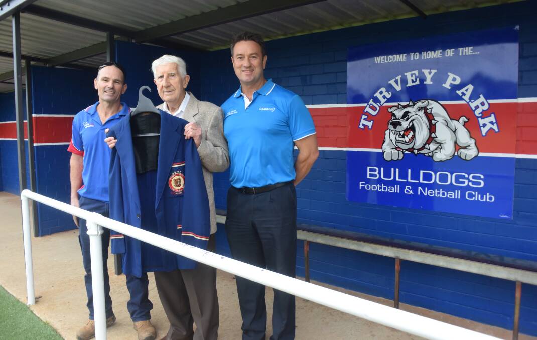SPECIAL GUEST: Turvey Park's inaugural coach, Gil Hoare, 92, presents his club blazer to co-coach Mark Carroll (left) and club president Steve Stapleton (right) at Maher Oval on Friday. Picture: Matt Malone