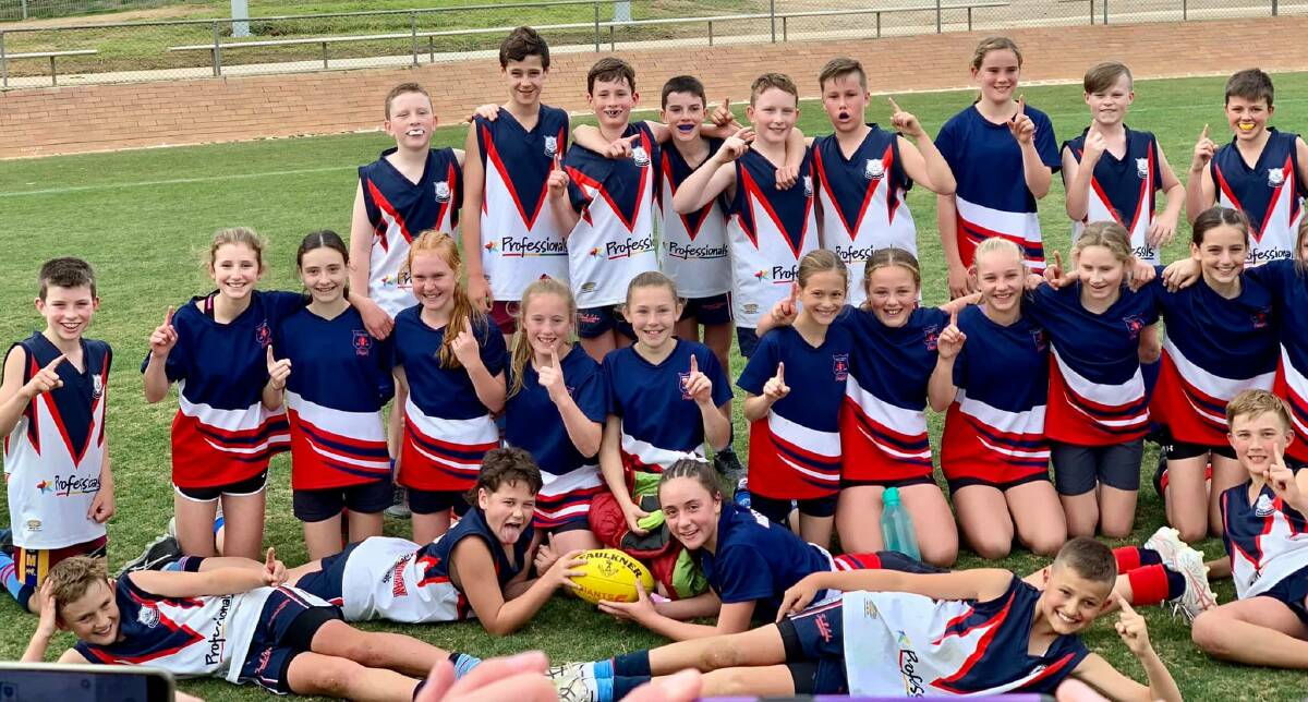 CHAMPIONS: Mater Dei Primary School's boys and girls teams celebrate their wins in the Southern NSW finals of the Paul Kelly Cup.