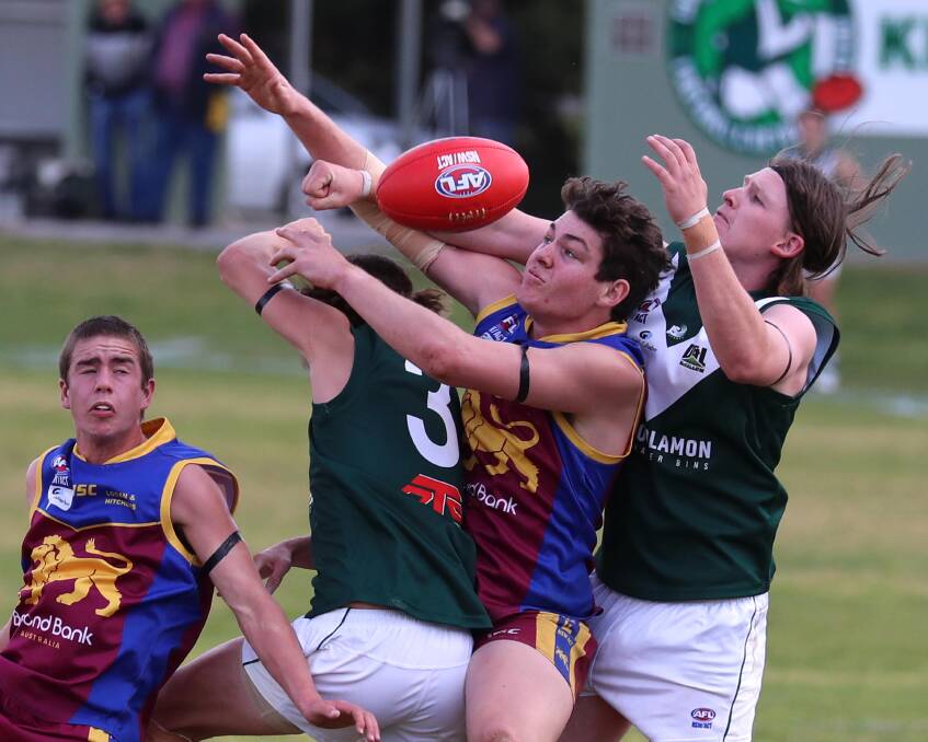 WHACK: GGGM's Riley Corbett crashes a pack with Coolamon's Sam Glyde and Will Graetz either side at Kindra Park on Saturday. Picture: Les Smith