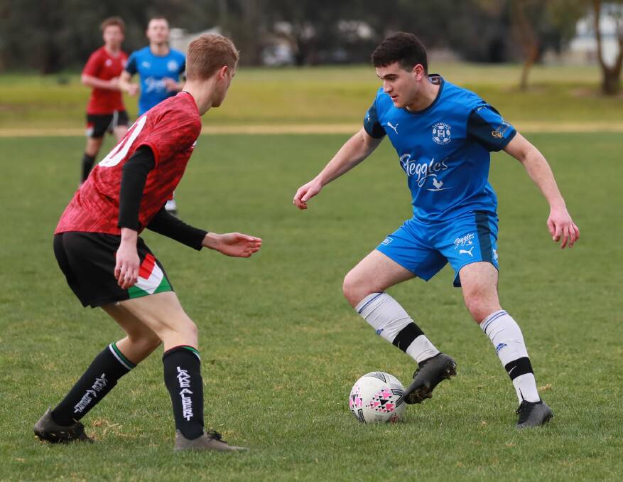 ON THE ATTACK: Hanwood's Jordan Bellato looks to get around Lake Albert's Jackson Manton in the Pascoe Cup match at Rawlings Park on Sunday. Picture: Les Smith