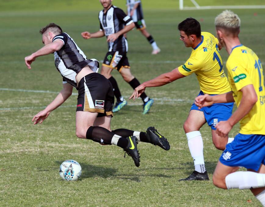 IN DOUBT: Jake Ploenges is brought down in last Saturday's loss to Yoogali at Gissing Oval. Ploenges is in doubt for this weekend due to a calf injury. Picture: Les Smith