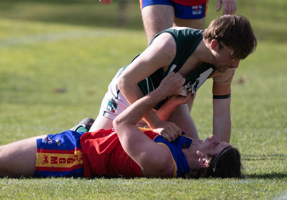 Ryan Cox gets up close and personal with GGGM's Matt Hamblin when playing at Coolamon last season. Picture by Madeline Begley