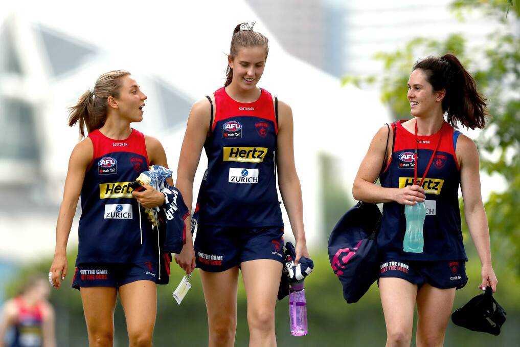 FLYING HIGH: Wagga's Gabby Colvin (right) with Melbourne teammates Eliza McNamara and Maggie Caris earlier this year at Gosch's Paddock. Picture: Getty Images