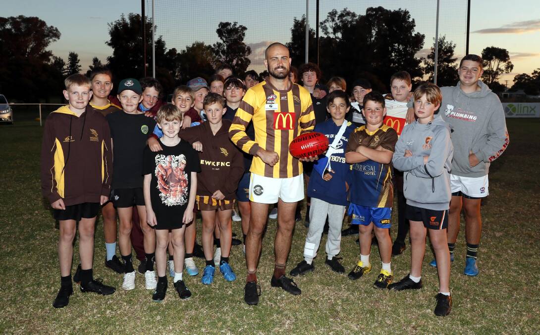 Brocke Argus with East Wagga-Kooringal's under 13 and 15s teams at training on Thursday night ahead of his 200th senior game for the Hawks on Saturday. Picture by Les Smith