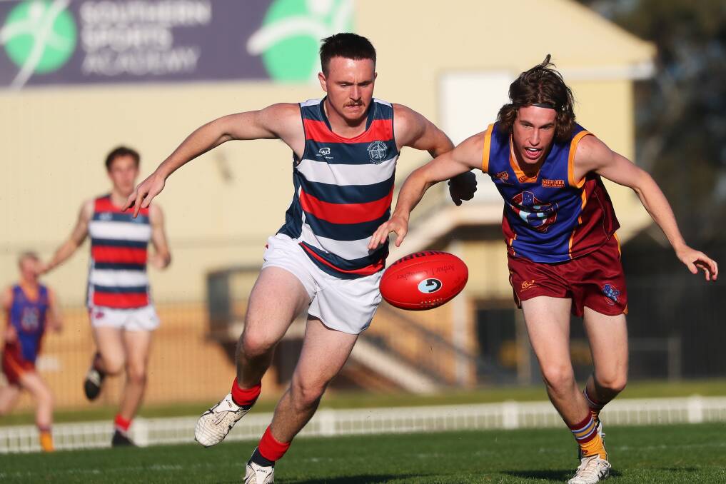 THE RACE IS ON: Kildare Catholic College's Riley Browning and Mater Dei Catholic College's Zac Randal fight for the ball in Monday's Carroll Cup game at Robertson Oval. Picture: Emma Hillier