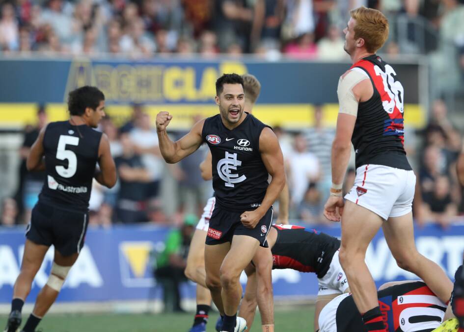 Mick Gibbons celebrates one of his three goals in the pre-season game against Essendon last month. 