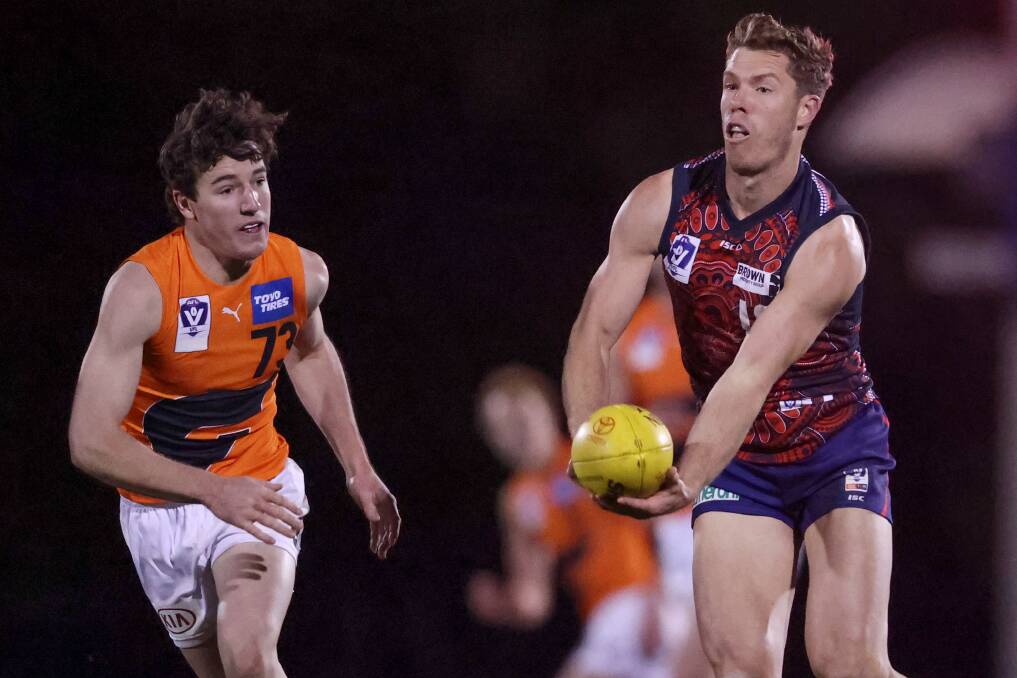 GREAT EXPERIENCE: Narrandera's Harry Grintell chases experienced AFL footballer Jake Melksham in the VFL game between GWS Giants and Casey Demons at Casey Fields on Saturday night. Picture: Getty Images