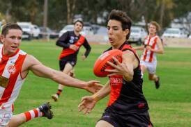 Marrar's Caleb Walker plucks the ball in one hand despite close attention from Charles Sturt University's Max Findlay at Langtry Oval on Saturday. Picture by Bernard Humphreys