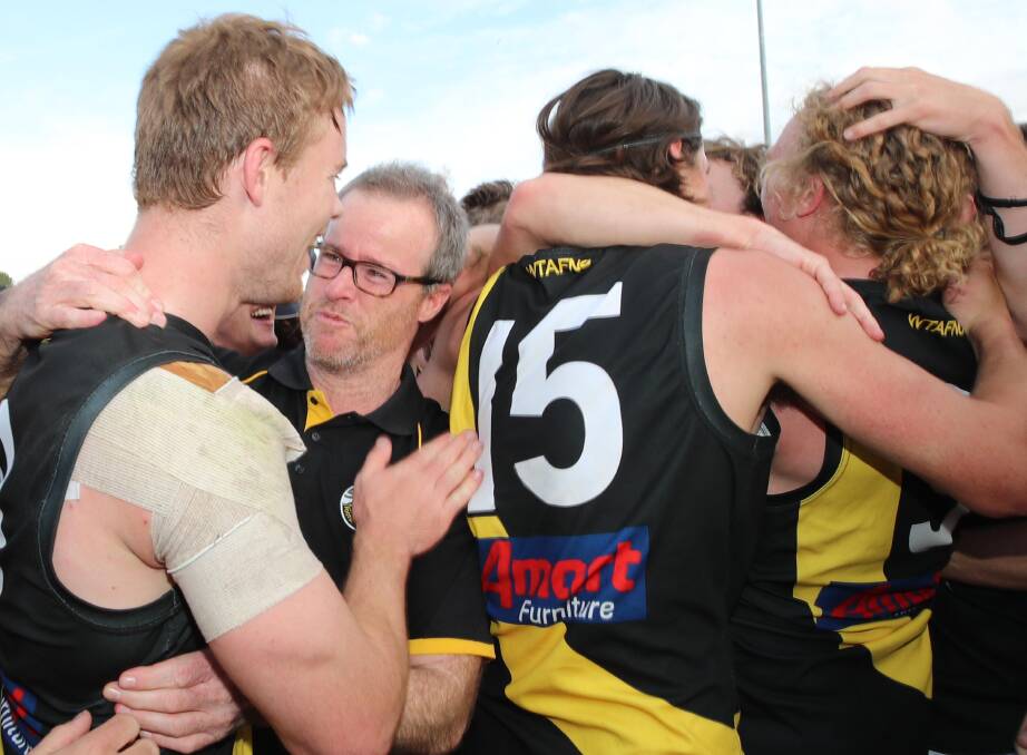 SPECIAL WIN: Wagga Tigers defender Dylan Morton (left) embraces coach Troy Maiden after the siren. Pictures: Les Smith