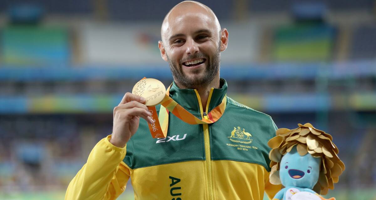 GOLDEN BOY: Temora's Scott Reardon shows off his Gold Medal after winning the men's T42 100m at the Rio Paralympics on Friday. Picture: Getty Images