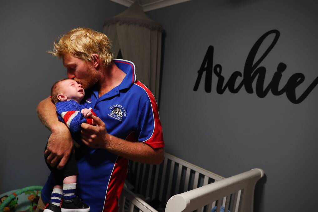 Jeremy Sykes at home with baby Archie on Friday. Picture: Emma Hillier