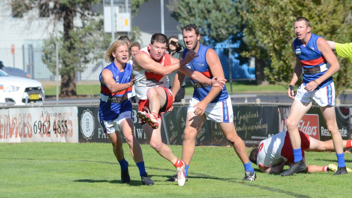 SUCCESS: Mick Duncan gets a kick away for Griffith during his 300th game on Saturday against Turvey Park at Exies Oval. Pictures: Liam Warren