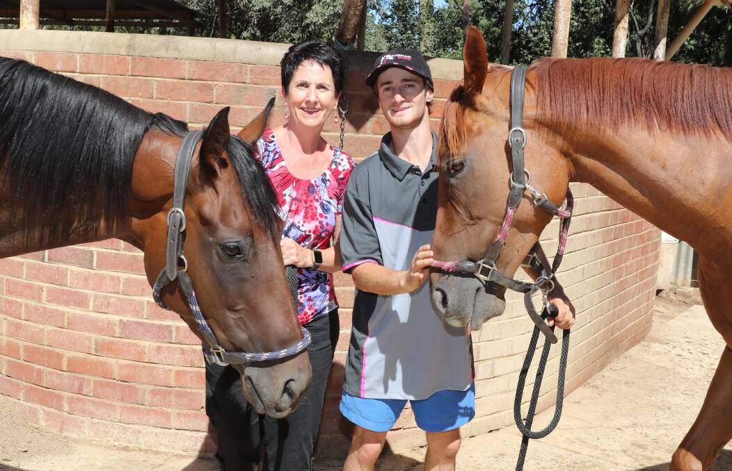 BATTLE READY: Maria Penfold and apprentice jockey Josh Richards with Takookacod and O' So Hazy (right) at Scott Spackman's stables on Thursday. Picture: Les Smith