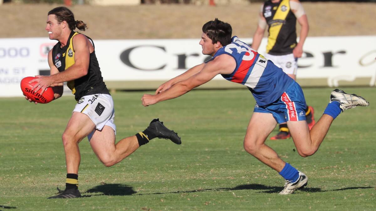 SPEED TO BURN: Wagga Tigers' Campbell Lovell gets away from Turvey Park's Bryce McPherson at Maher Oval on Saturday. Picture: Les Smith