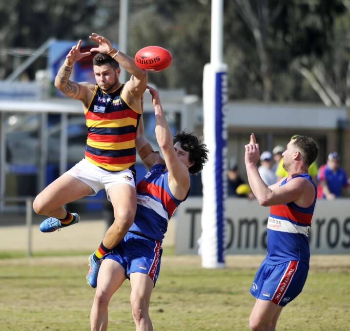 HIGH FLYER: Leeton-Whitton forward Daniel Muir attempts to mark against Turvey Park at Maher Oval on Saturday. Picture: Chelsea Sutton